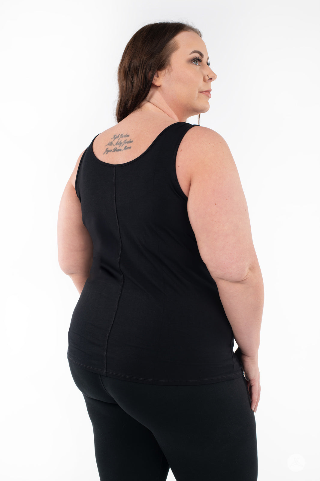 Plus-size woman facing sideways modeling SweetLegs Canada Classic Tank in black on white background