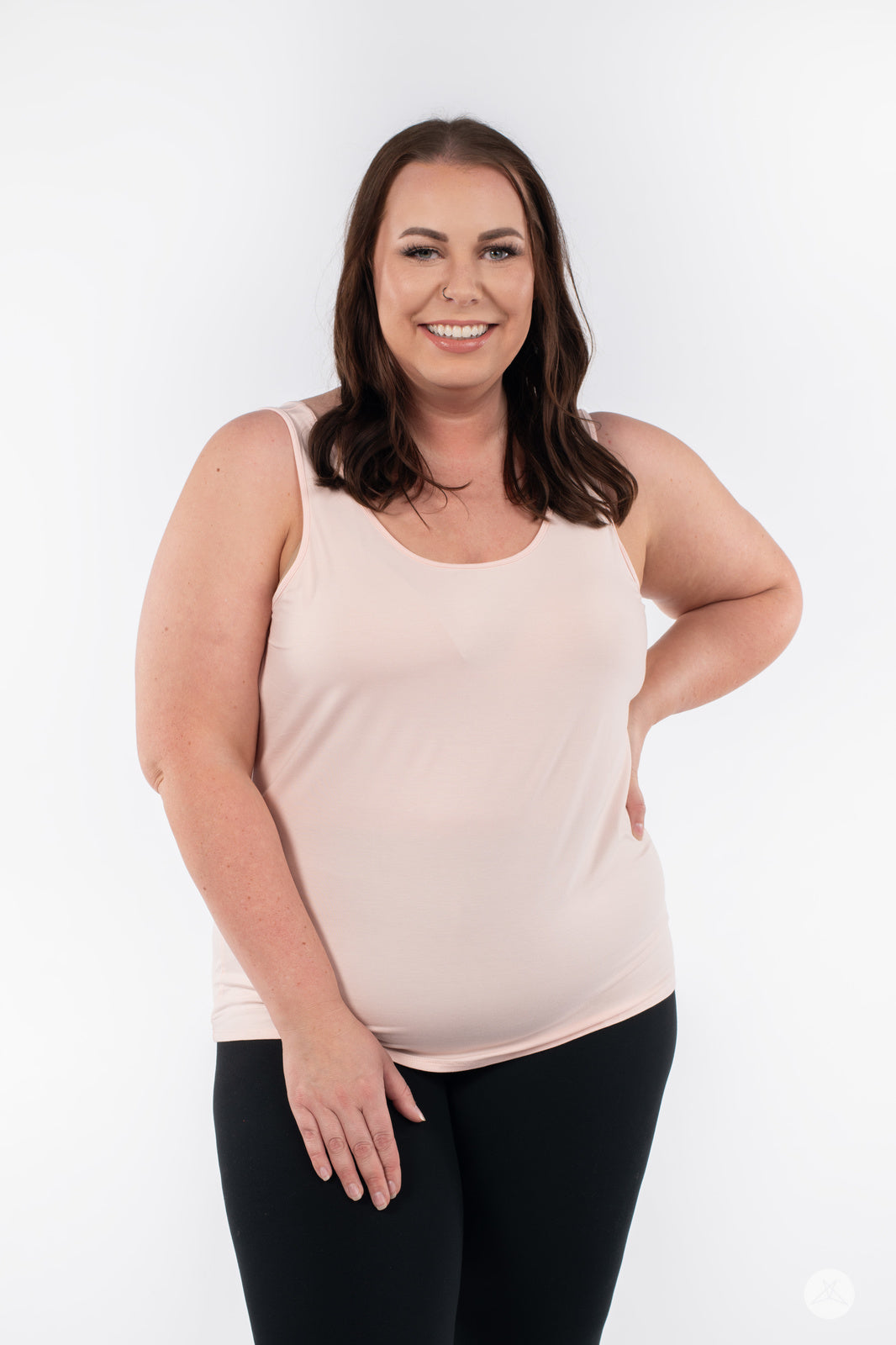 Smiling plus-size woman modeling SweetLegs Canada Classic Tank in latte with black leggings on white background