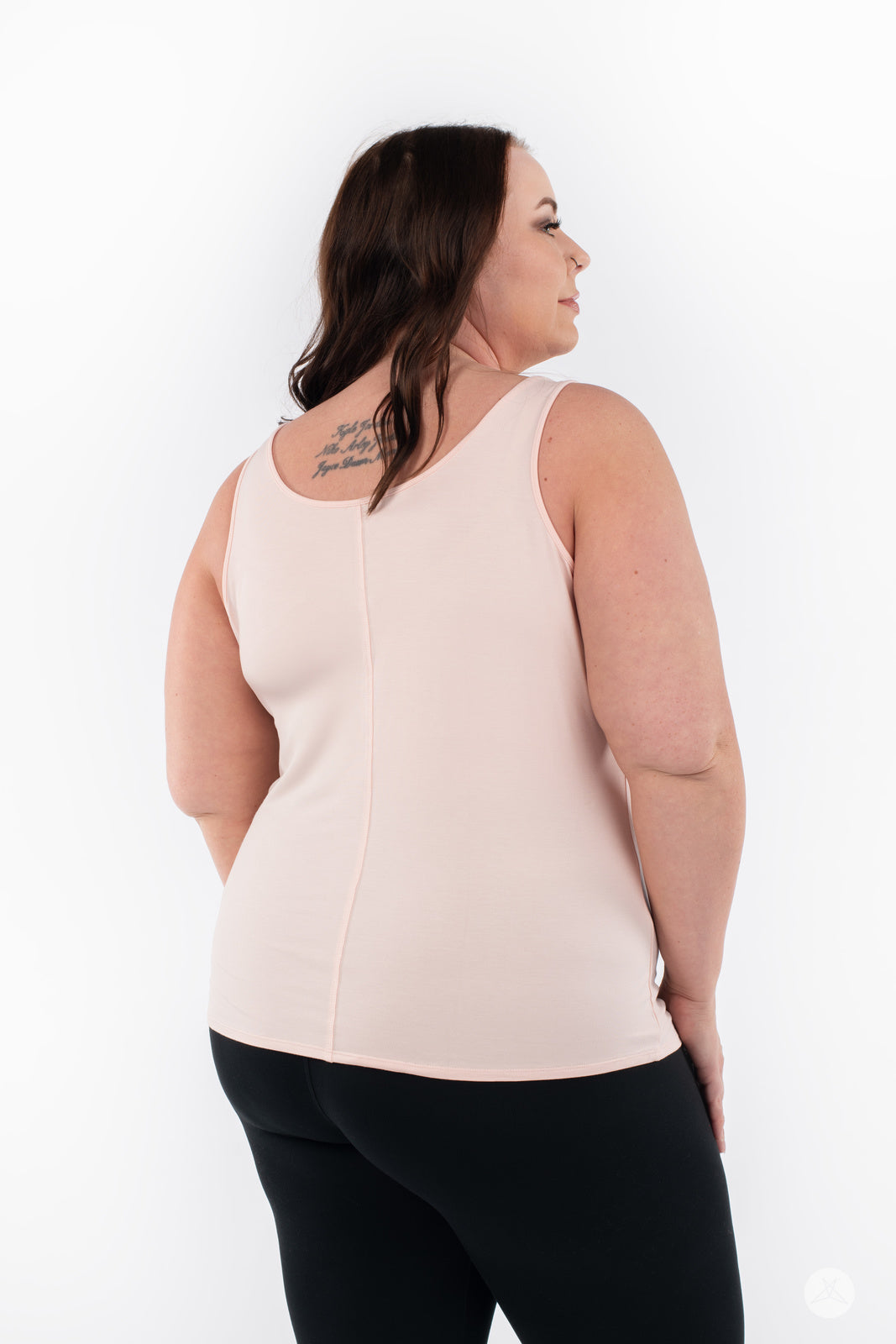 Plus-size model showing back view of SweetLegs Canada Classic Tank in latte paired with black bottoms on white background