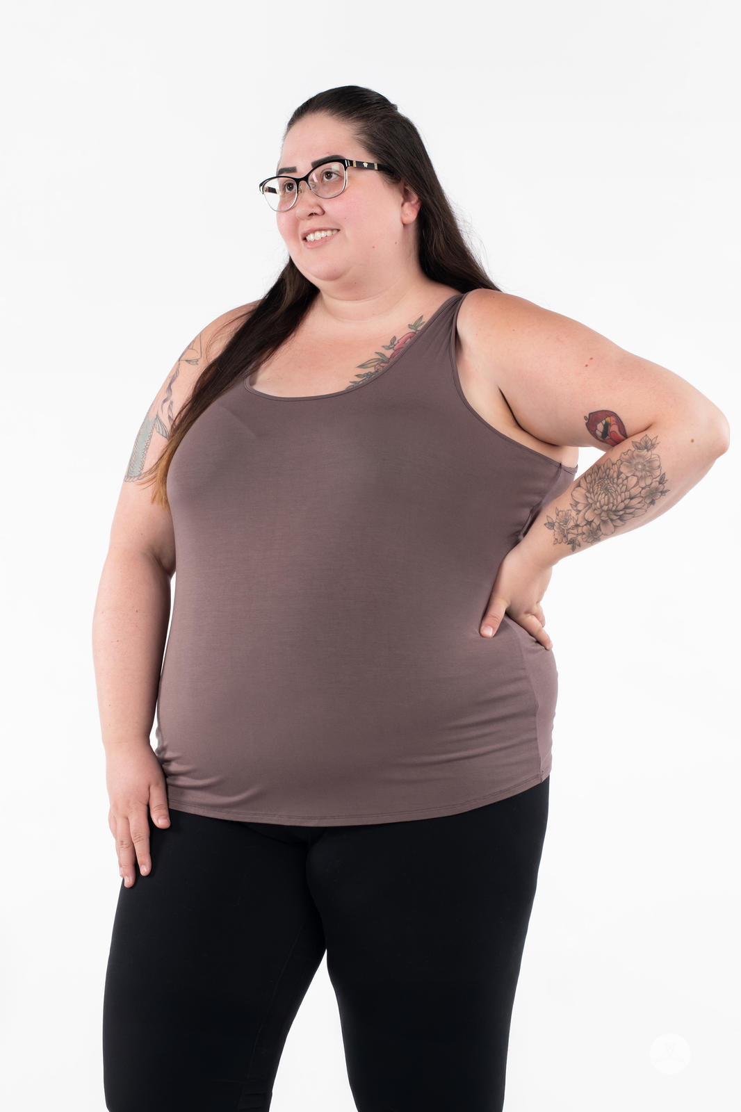Plus-size woman with glasses wearing SweetLegs Canada Classic Tank in brown paired with black pants on white background