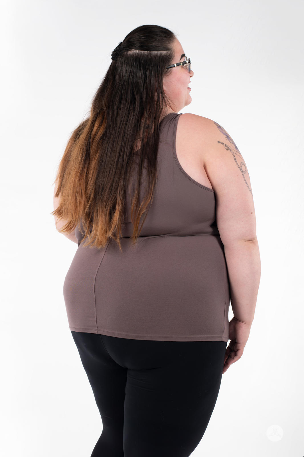 Plus-size woman shown from back modeling SweetLegs Canada Classic Tank in brown paired with black bottoms on white background