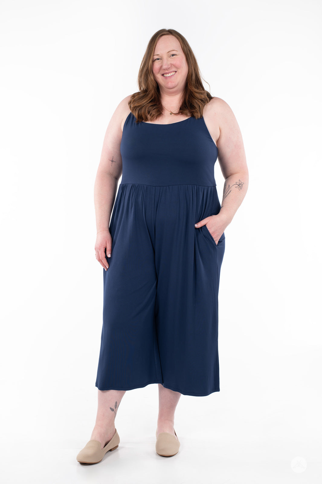 Plus-size model standing and smiling in navy blue SweetLegs Cropped Wide Leg Jumpsuit with pockets and relaxed fit