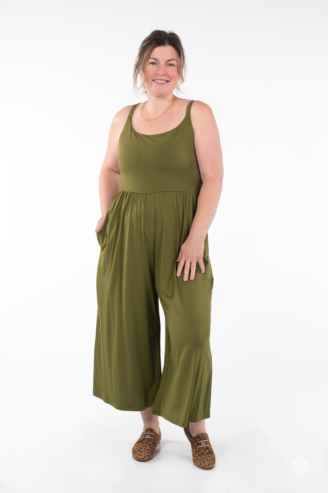 Plus-size model wearing SweetLegs Cropped Wide Leg Jumpsuit in olive green with relaxed sleeveless fit and pockets