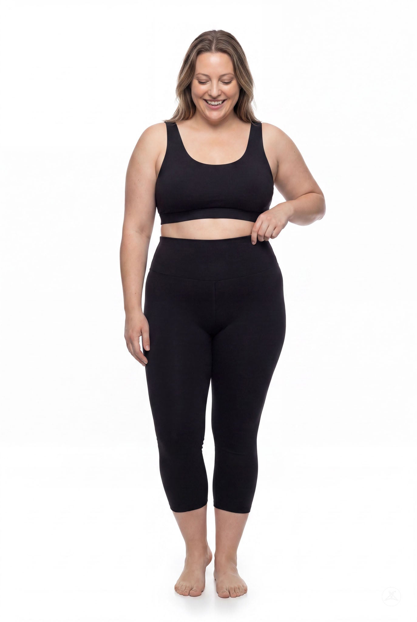Smiling woman wearing SweetLegs Black High-Waisted Crops with a wide waistband and cropped length front view barefoot