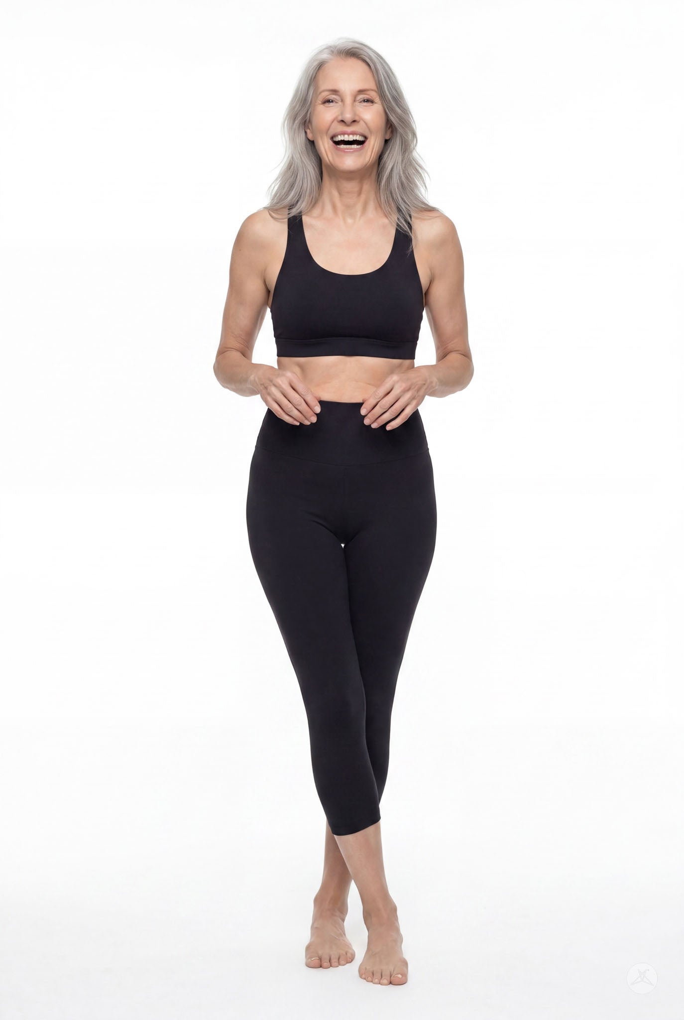 Smiling mature woman wearing SweetLegs Black High-Waisted Crops with a smooth high waistband, front view barefoot