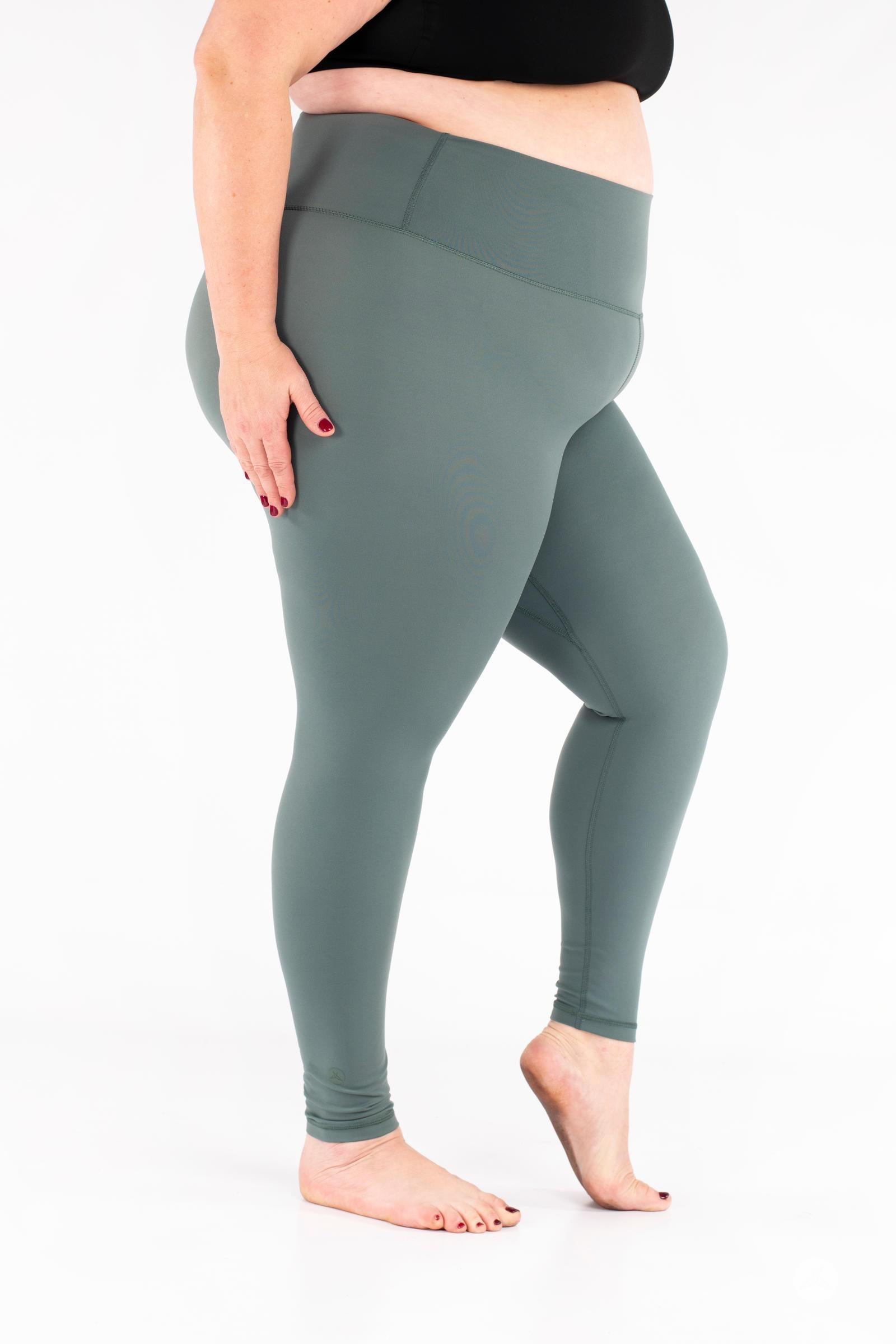Plus-size woman wearing green Free Motion Leggings by SweetLegs Athleisure standing barefoot side view