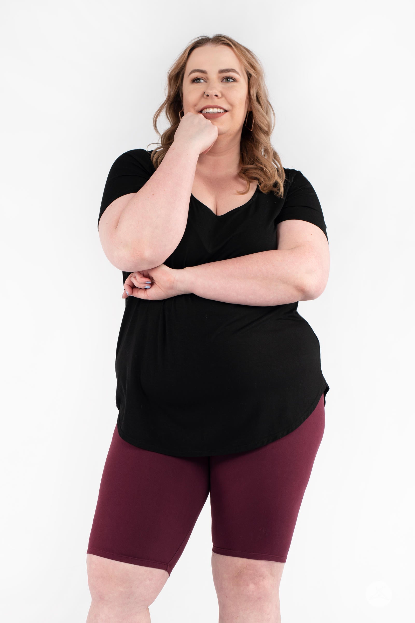 SweetLegs Mulberry Biker Shorts in deep maroon worn with black top on smiling plus-size model against white background