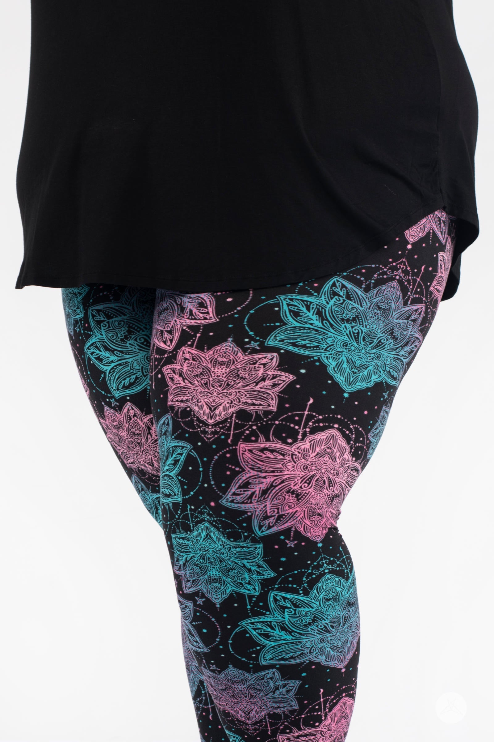 Close-up of SweetLegs Everafter Crops with pink and teal floral mandala pattern on black background