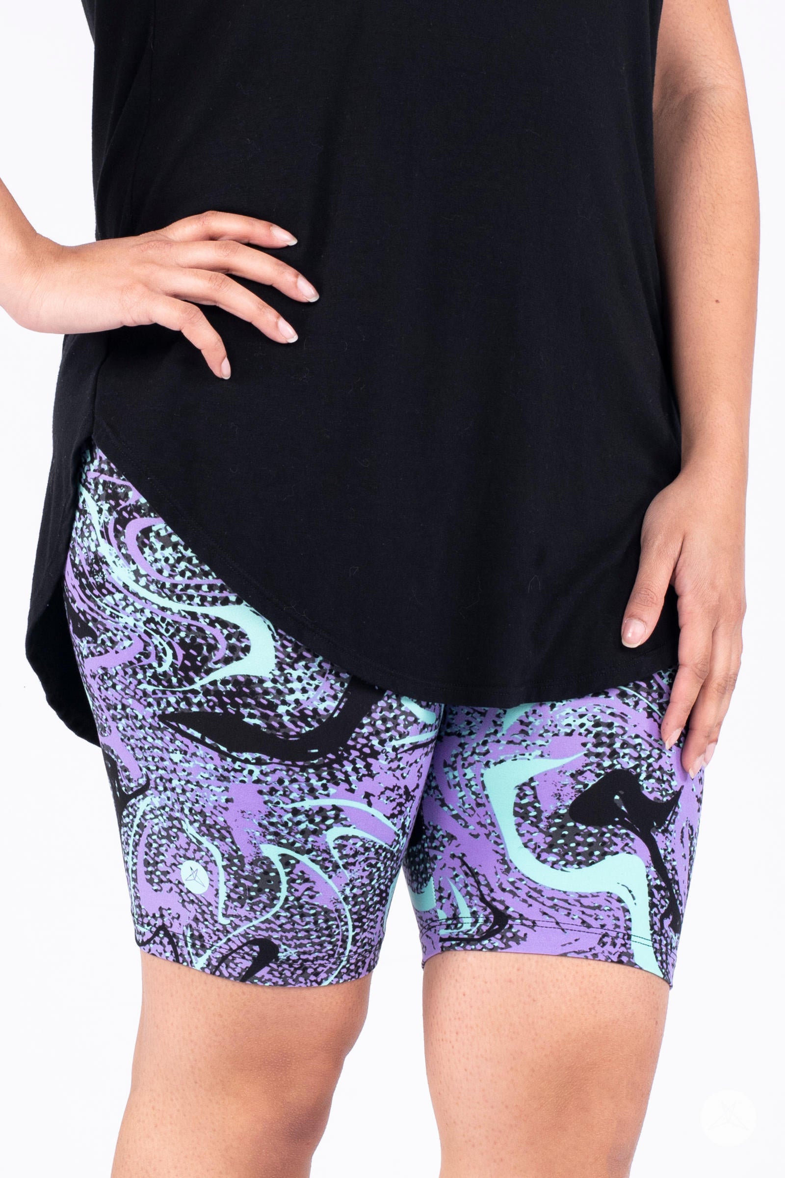 Close-up of a person wearing SweetLegs Mint Condition Biker Shorts with abstract blue and purple pattern and black top