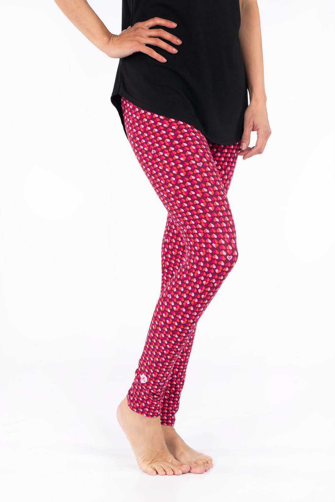 Side view of SweetLegs Lovesick leggings featuring bold duo-colored pink and purple hearts worn barefoot