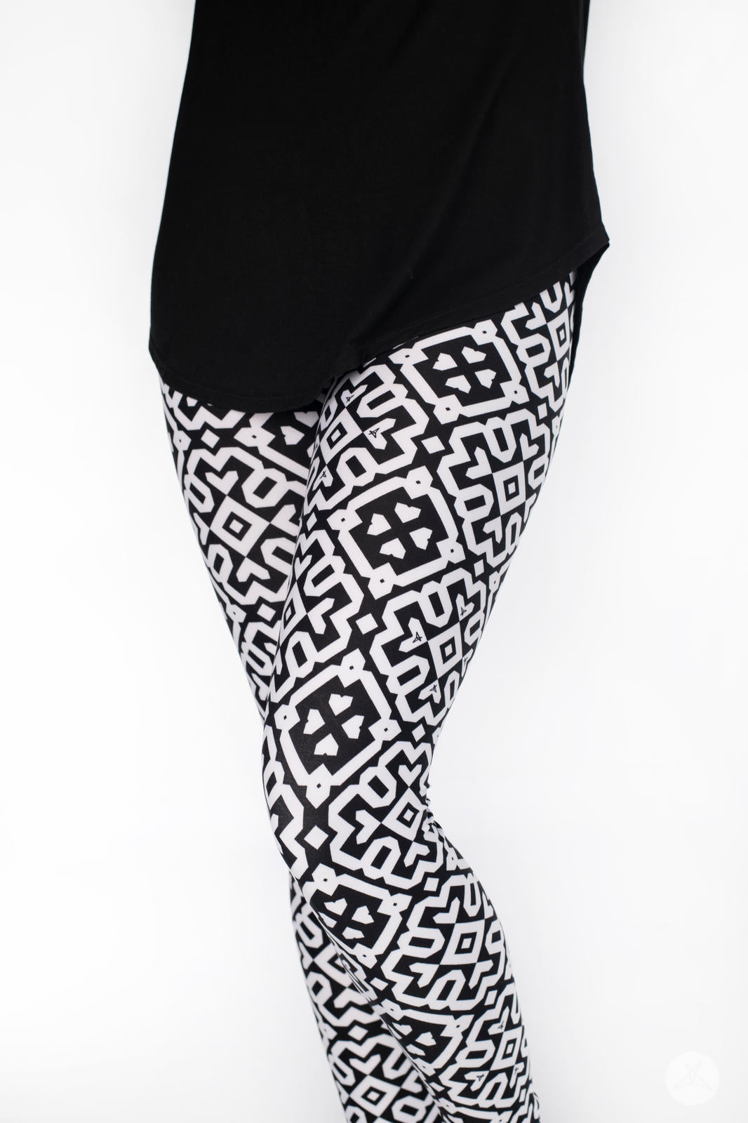 Legs wearing SweetLegs Audrey leggings with bold black and white Moroccan geometric tile pattern and black top