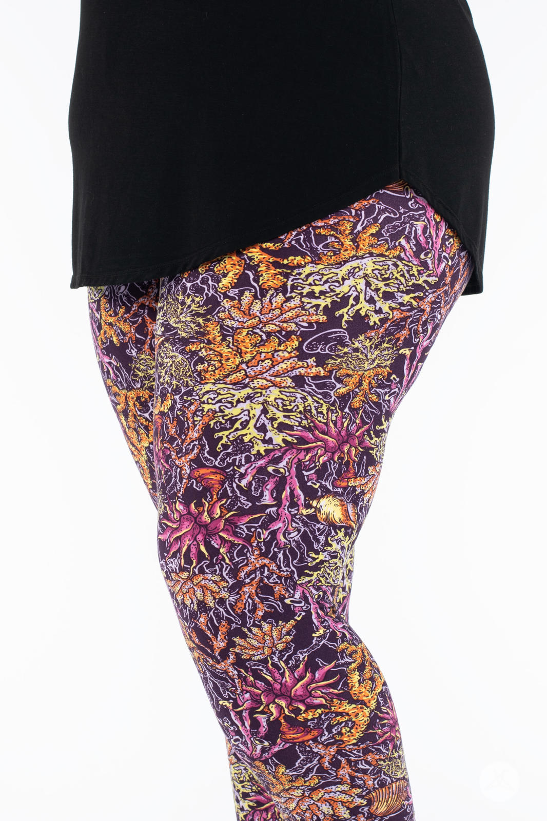 Close-up side view of SweetLegs Coral Cove Crops featuring vibrant coral pattern and comfortable cropped fit above ankle