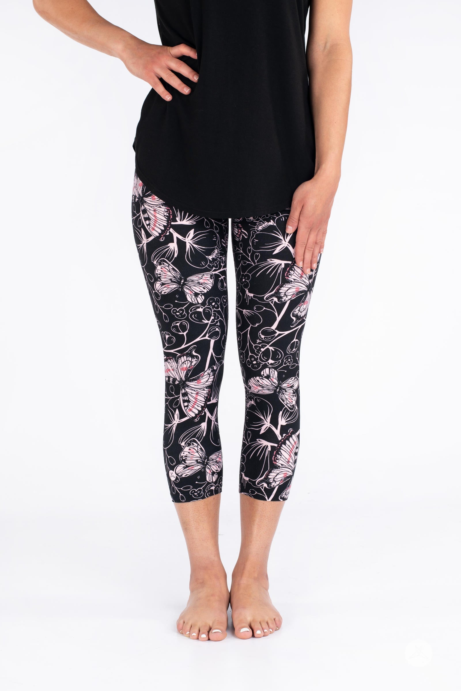 Front view of SweetLegs Butterfly Bliss 2.0 Crops with pink butterfly and floral pattern on black fabric