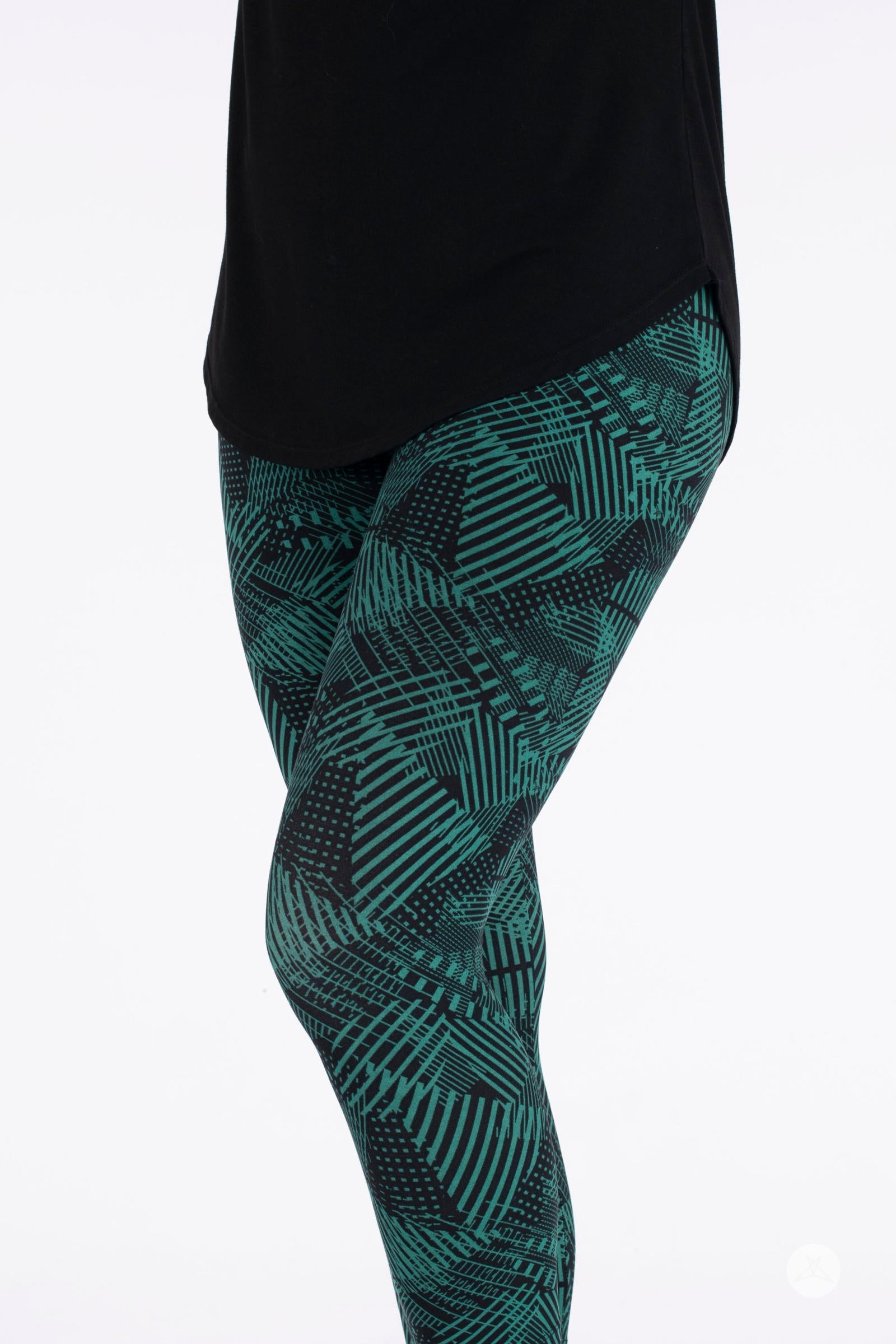 Close-up of SweetLegs Geometric Glam Crops featuring green and black patterned cropped leggings on white background