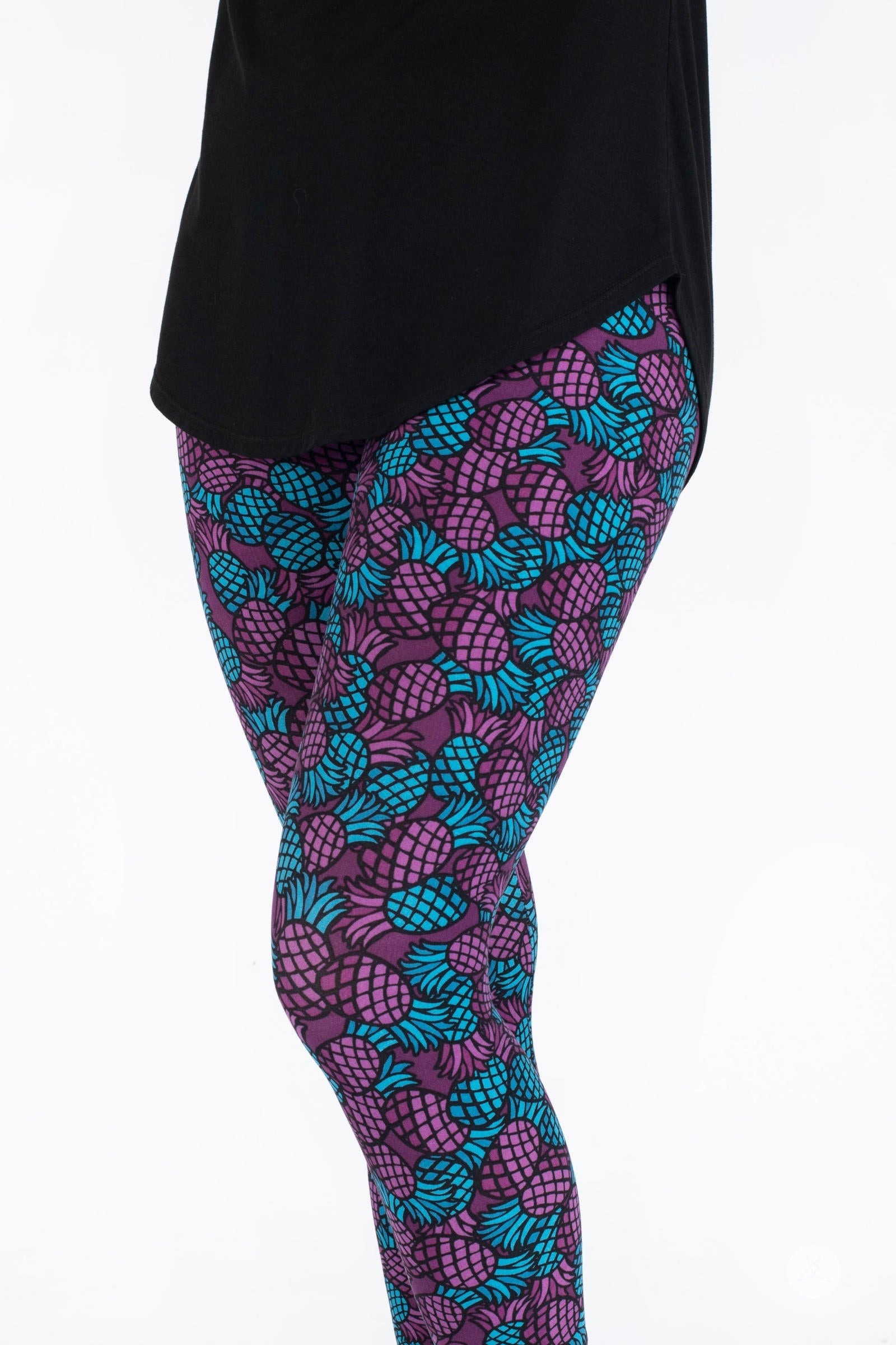 Side angle of SweetLegs Razzle Dazzle Crops with purple and blue pineapple pattern on cropped leggings
