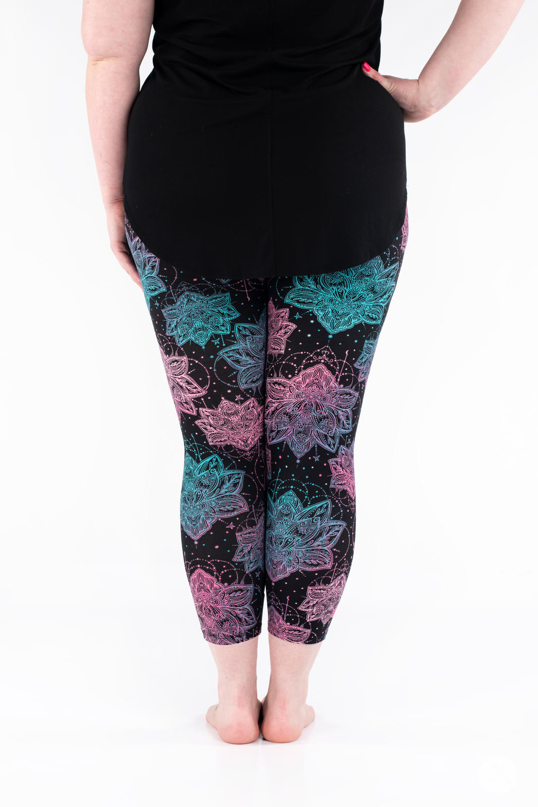 Rear view of SweetLegs Everafter Crops featuring pink and teal floral mandala patterns on black background