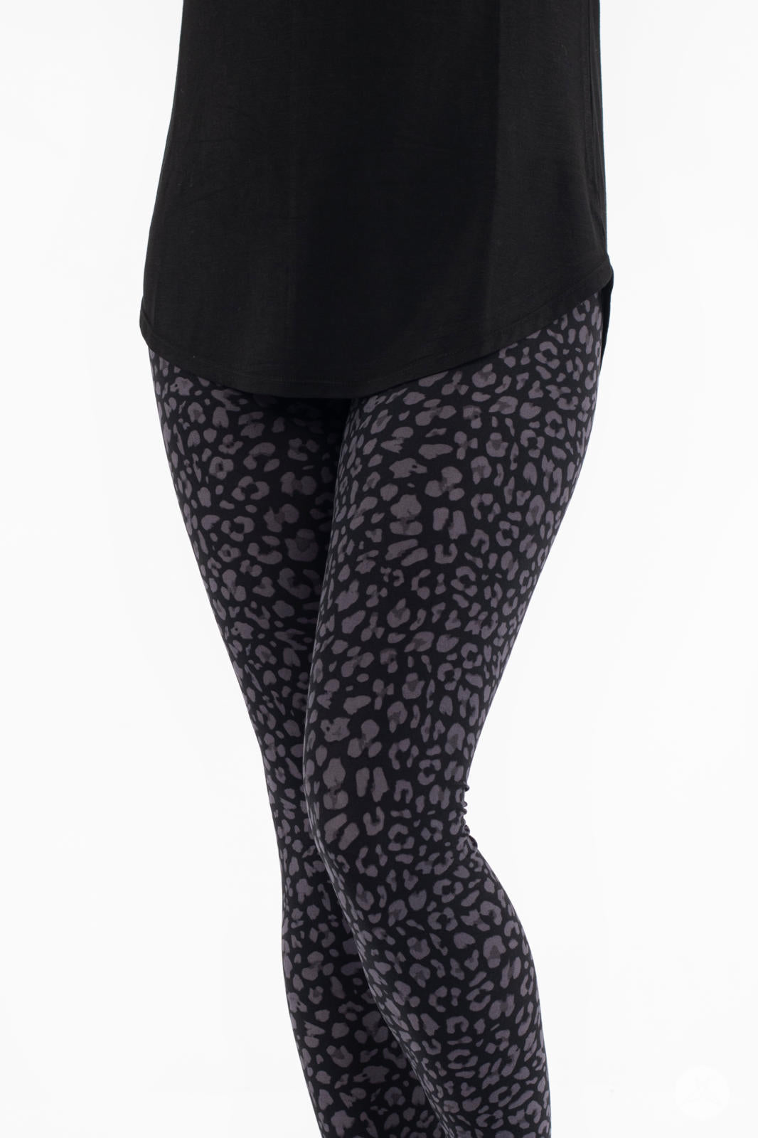 SweetLegs Shadow Hunter leggings featuring a scaled grey cheetah print pattern on black fabric shown on model’s legs