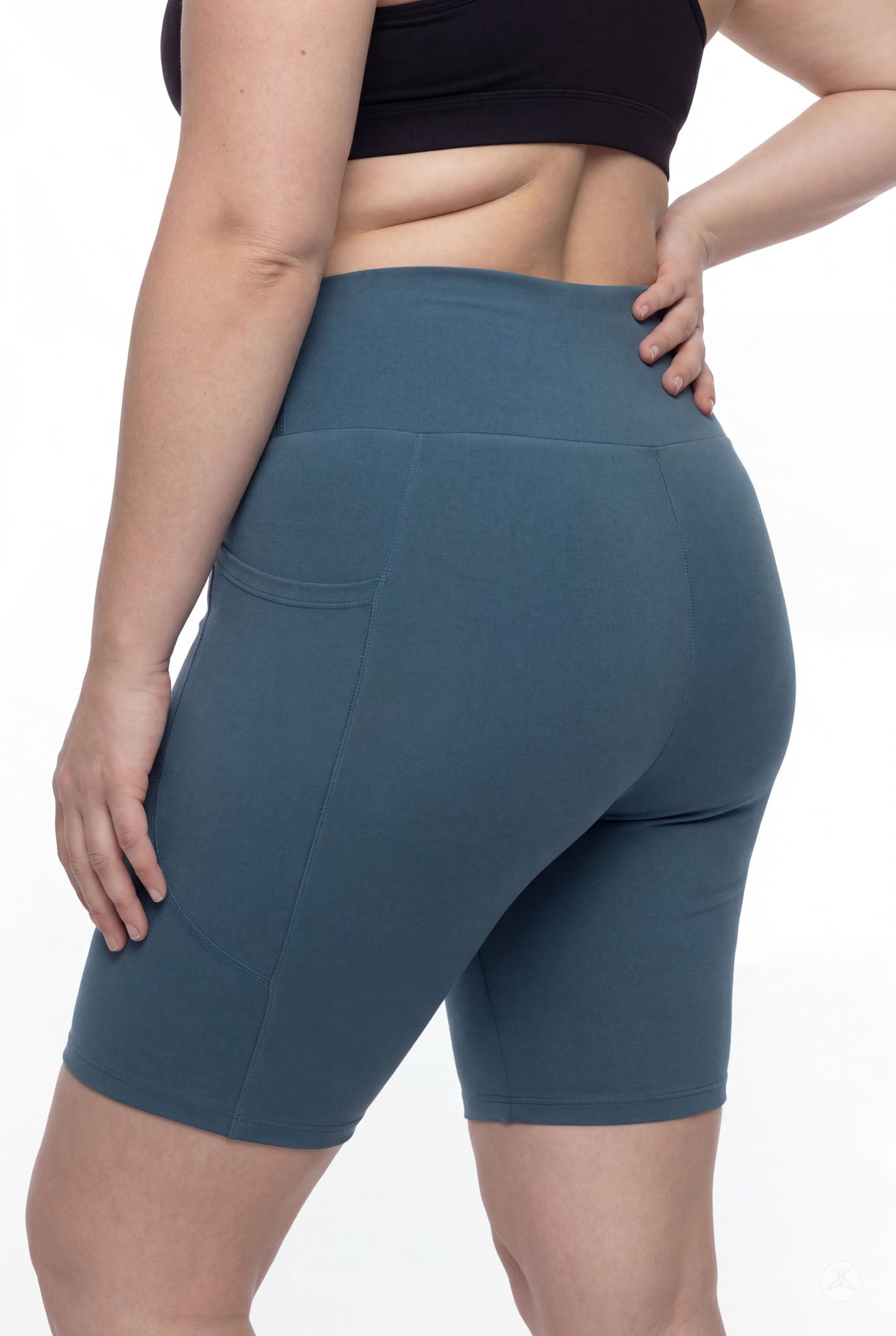 Plus size model wearing SweetLegs Deep Teal High-Waisted Pocket Biker Shorts highlighting side pocket and smooth waistband details