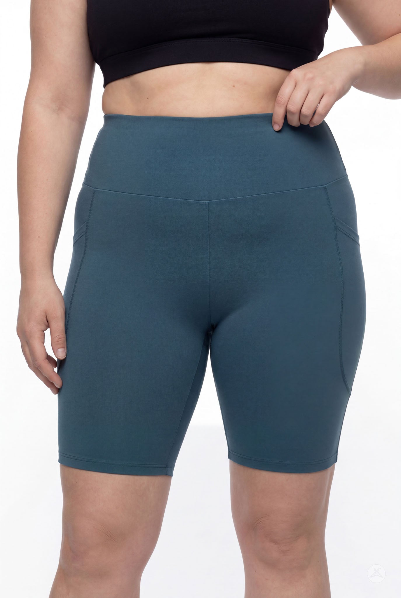 Woman wearing SweetLegs Deep Teal High-Waisted Pocket Biker Shorts showing smooth waistband and side pocket details
