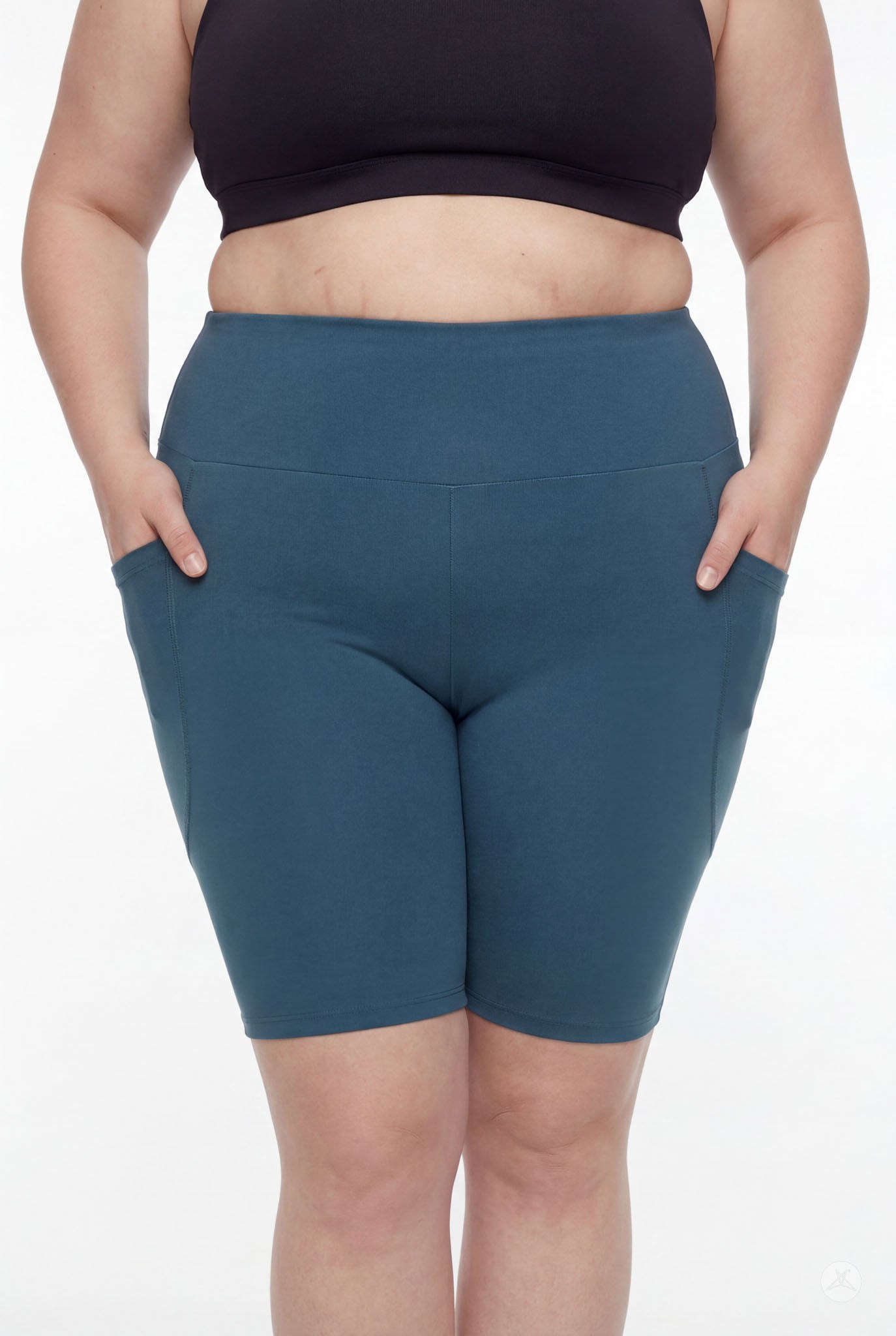 Plus size model wearing SweetLegs Deep Teal High-Waisted Pocket Biker Shorts with side pockets and signature elastic waistband
