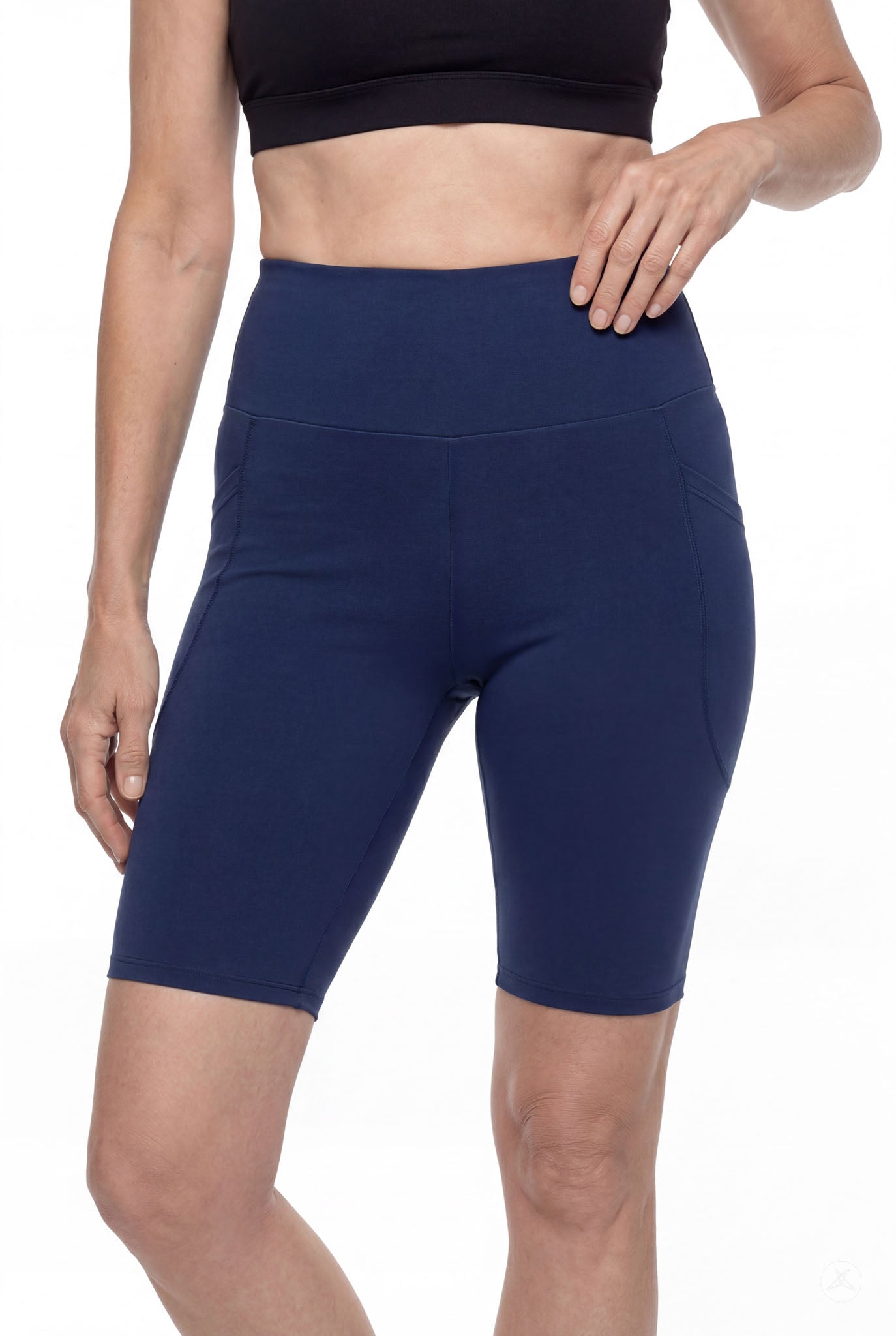 Woman wearing navy SweetLegs Still Water High-Waisted Pocket Biker Shorts with side pockets and black crop top