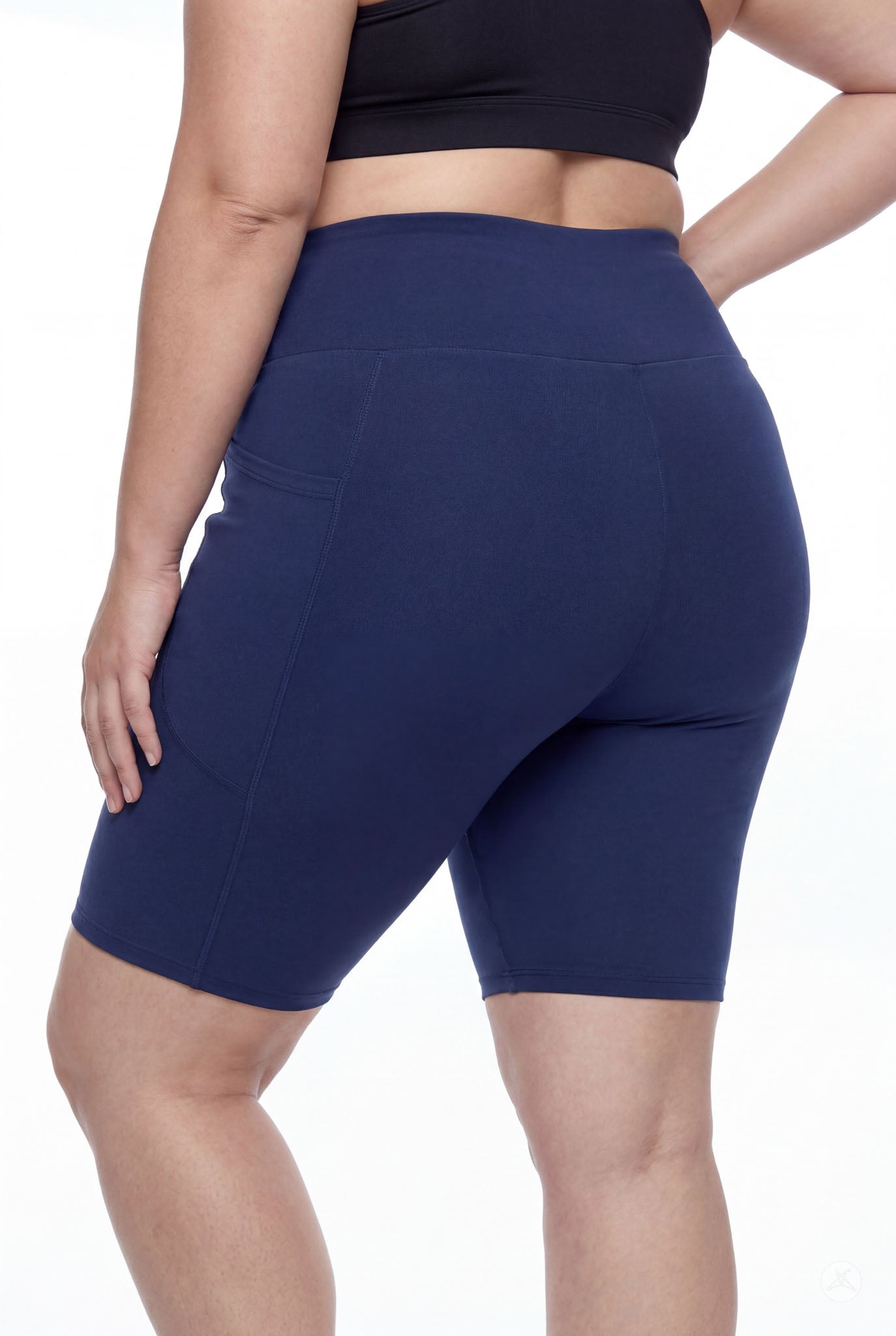 Plus size model wearing SweetLegs Still Water High-Waisted Pocket Biker Shorts in navy showing rear and pocket details