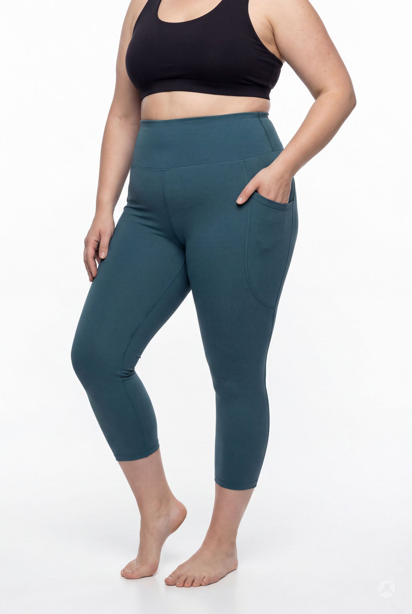 Woman wearing SweetLegs Deep Teal High-Waisted Pocket Crops with hand in side pocket barefoot front side view