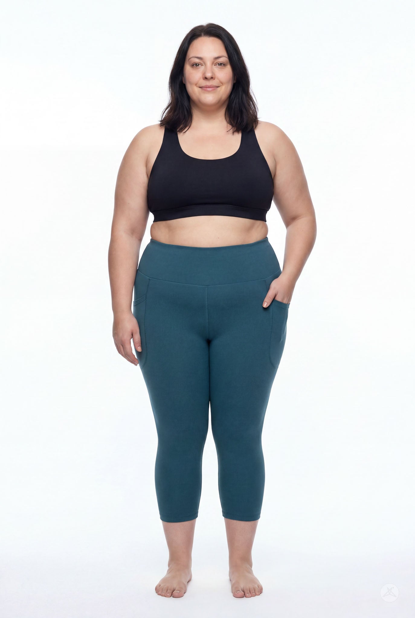 Plus size model wearing SweetLegs Deep Teal High-Waisted Pocket Crops with hand in side pocket barefoot front view