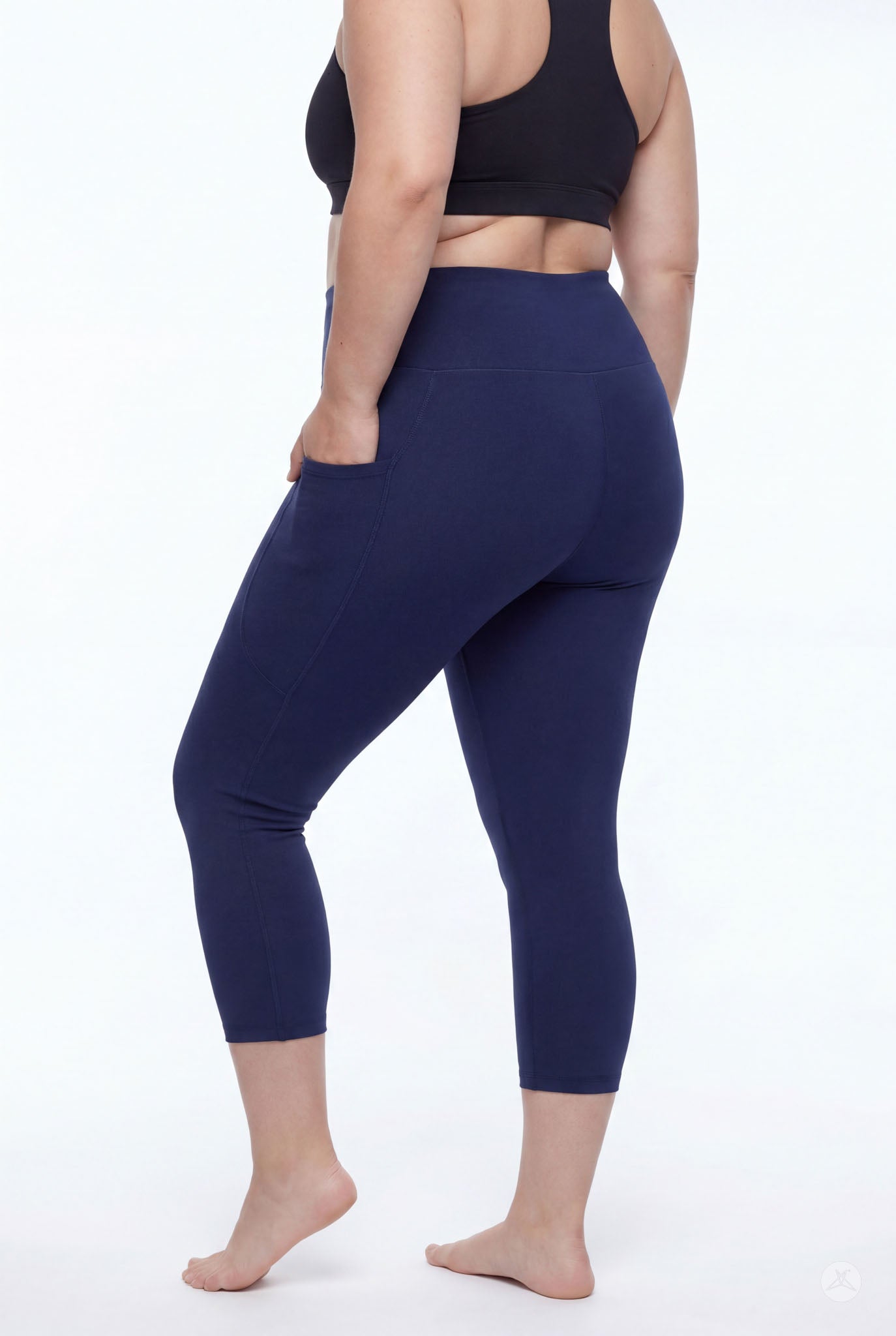 Woman wearing SweetLegs Still Water High-Waisted Pocket Crops in navy with side pocket barefoot back view