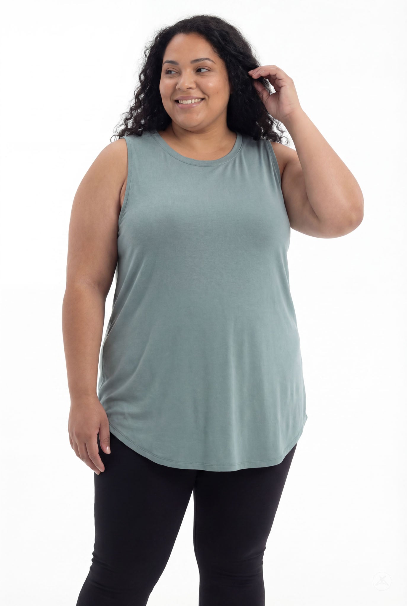Plus size woman smiling wearing SweetTops High Neck Swing Tank in soft muted green with sleeveless relaxed fit from front angle
