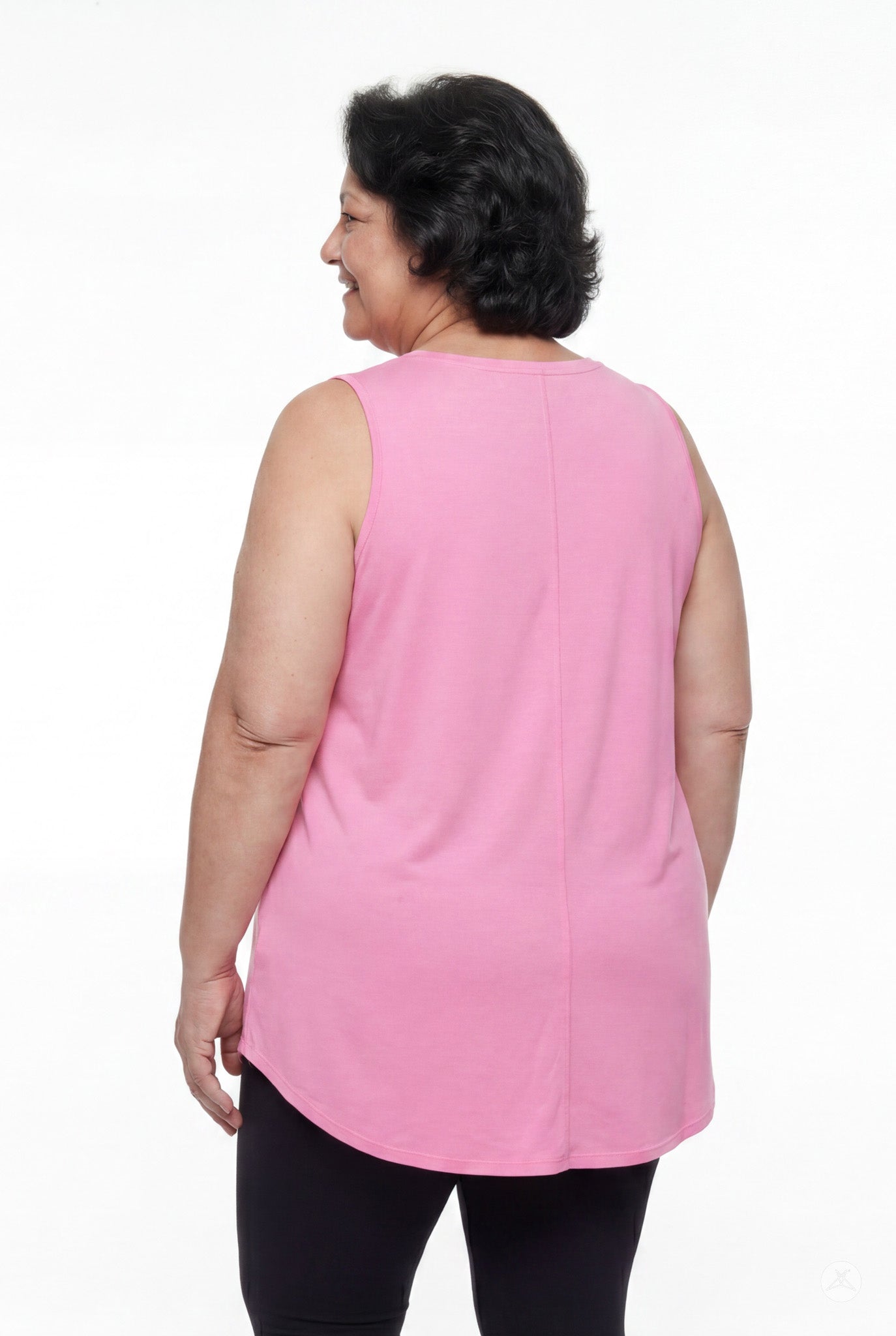 Plus size woman smiling wearing SweetTops High Neck Swing Tank in soft pink shown from back with sleeveless design