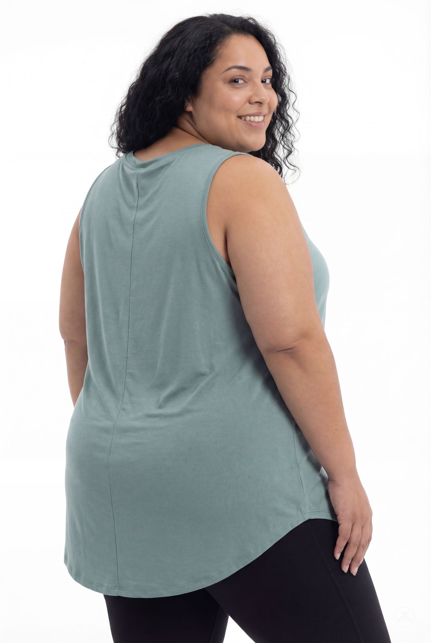Plus size model smiling wearing SweetTops High Neck Swing Tank in soft muted blue with relaxed sleeveless fit shown from back