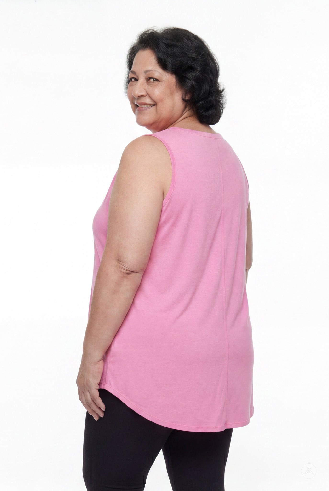 Plus size woman smiling wearing SweetTops High Neck Swing Tank in soft pink with relaxed fit shown from behind