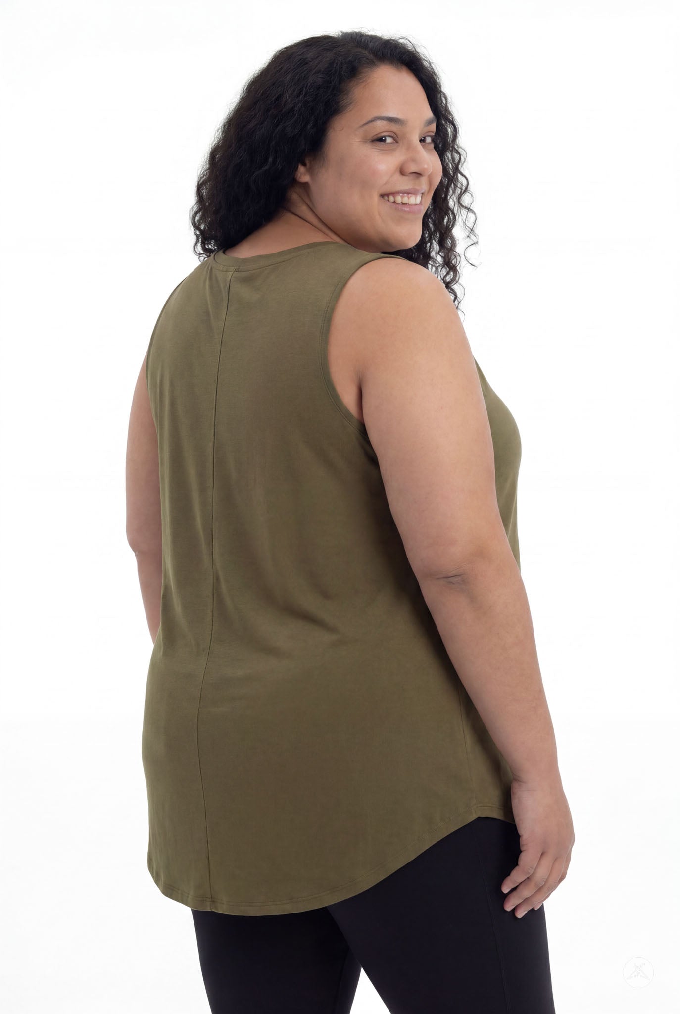 Plus size model smiling over shoulder wearing olive High Neck Swing Tank by SweetTops with black leggings on white background