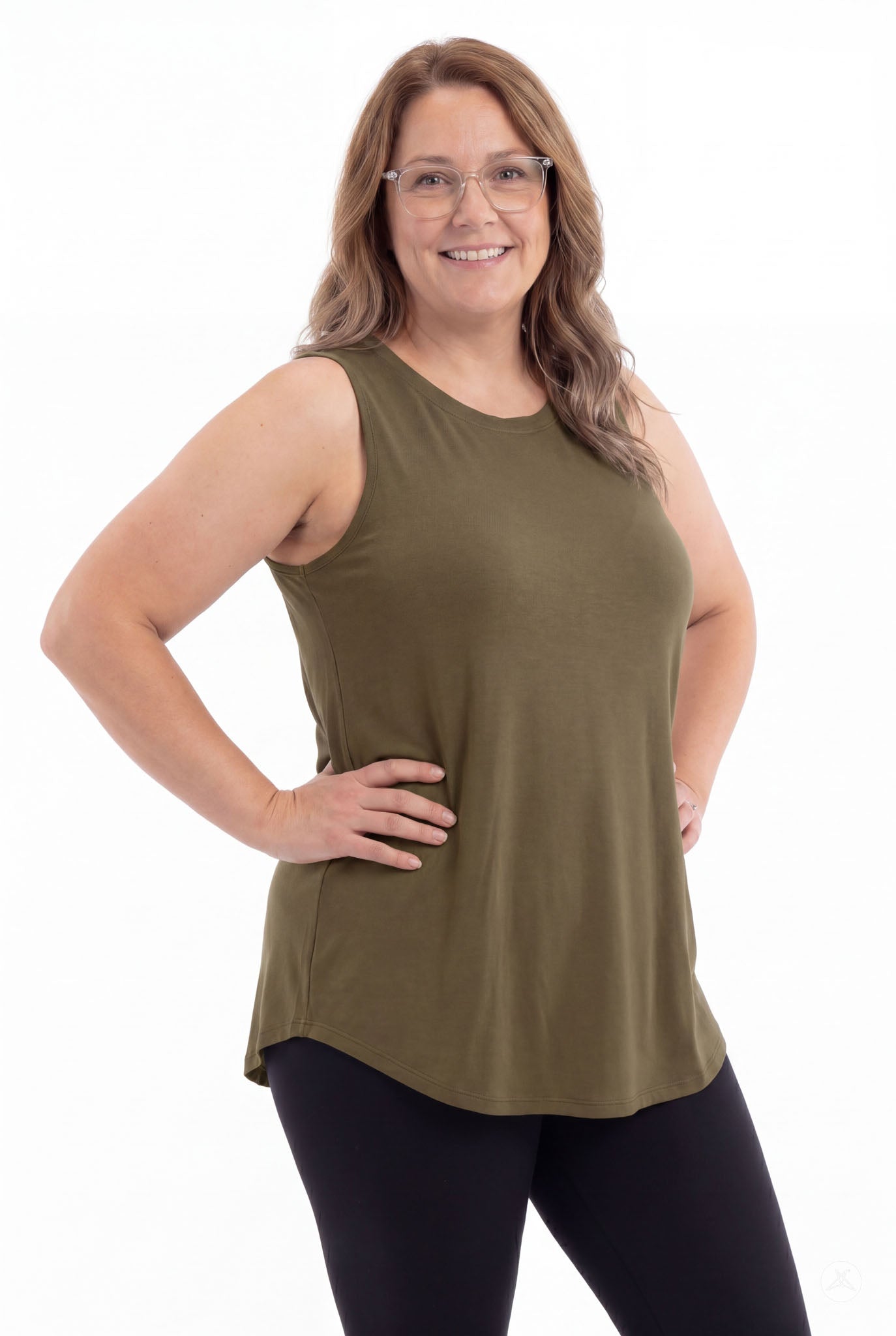 Smiling woman wearing olive High Neck Swing Tank by SweetTops paired with black leggings on white background
