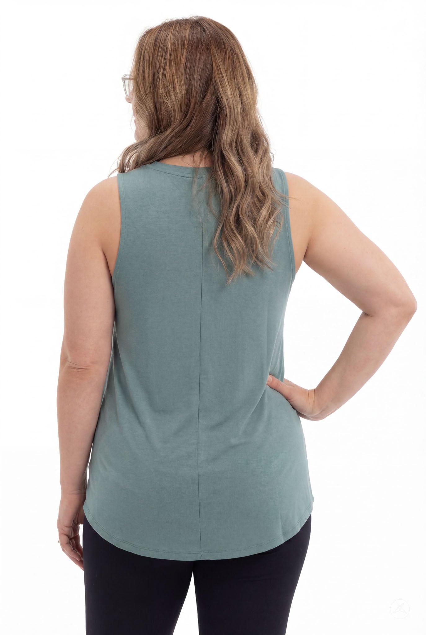 Plus size woman seen from back wearing SweetTops High Neck Swing Tank in soft muted teal with sleeveless relaxed fit