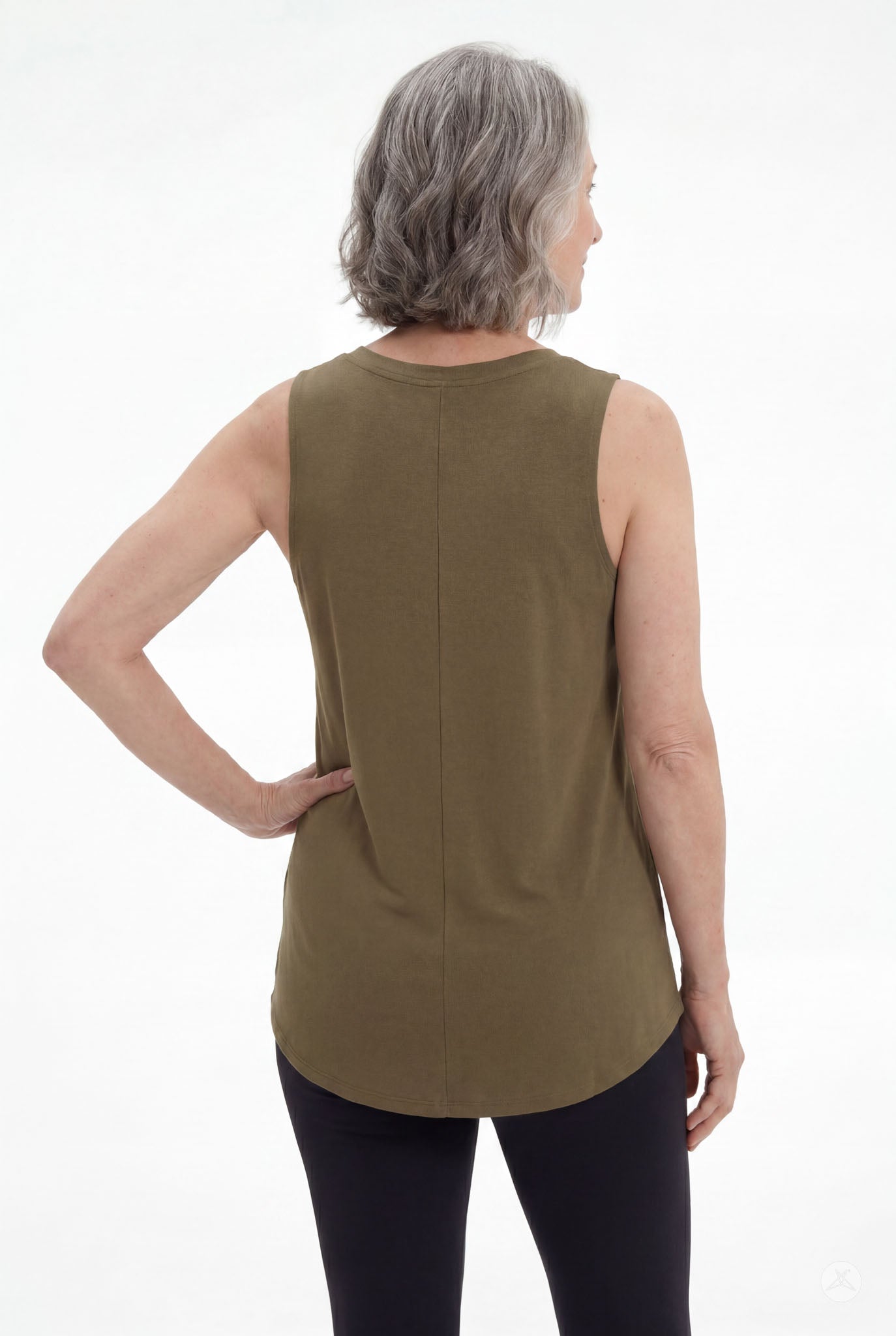 Woman shown from back wearing olive High Neck Swing Tank by SweetTops paired with black leggings on white background