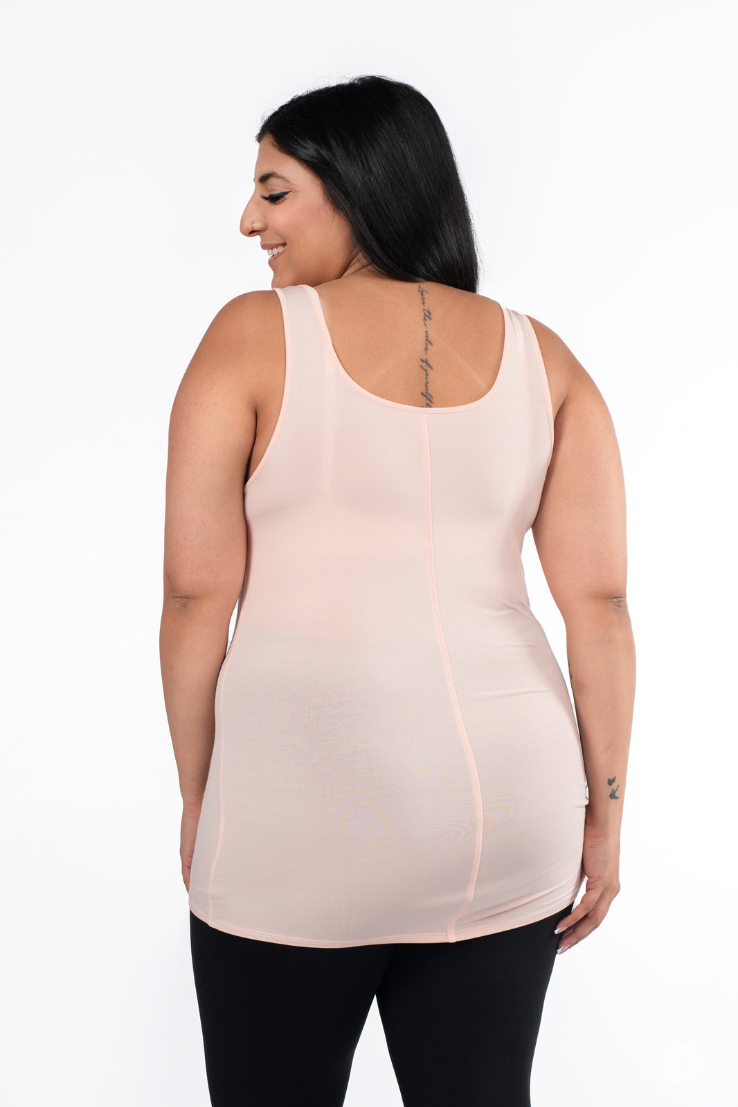 Plus-size woman smiling wearing SweetLegs Canada Classic Layering Tank in pale pink with a smooth, flattering fit from behind