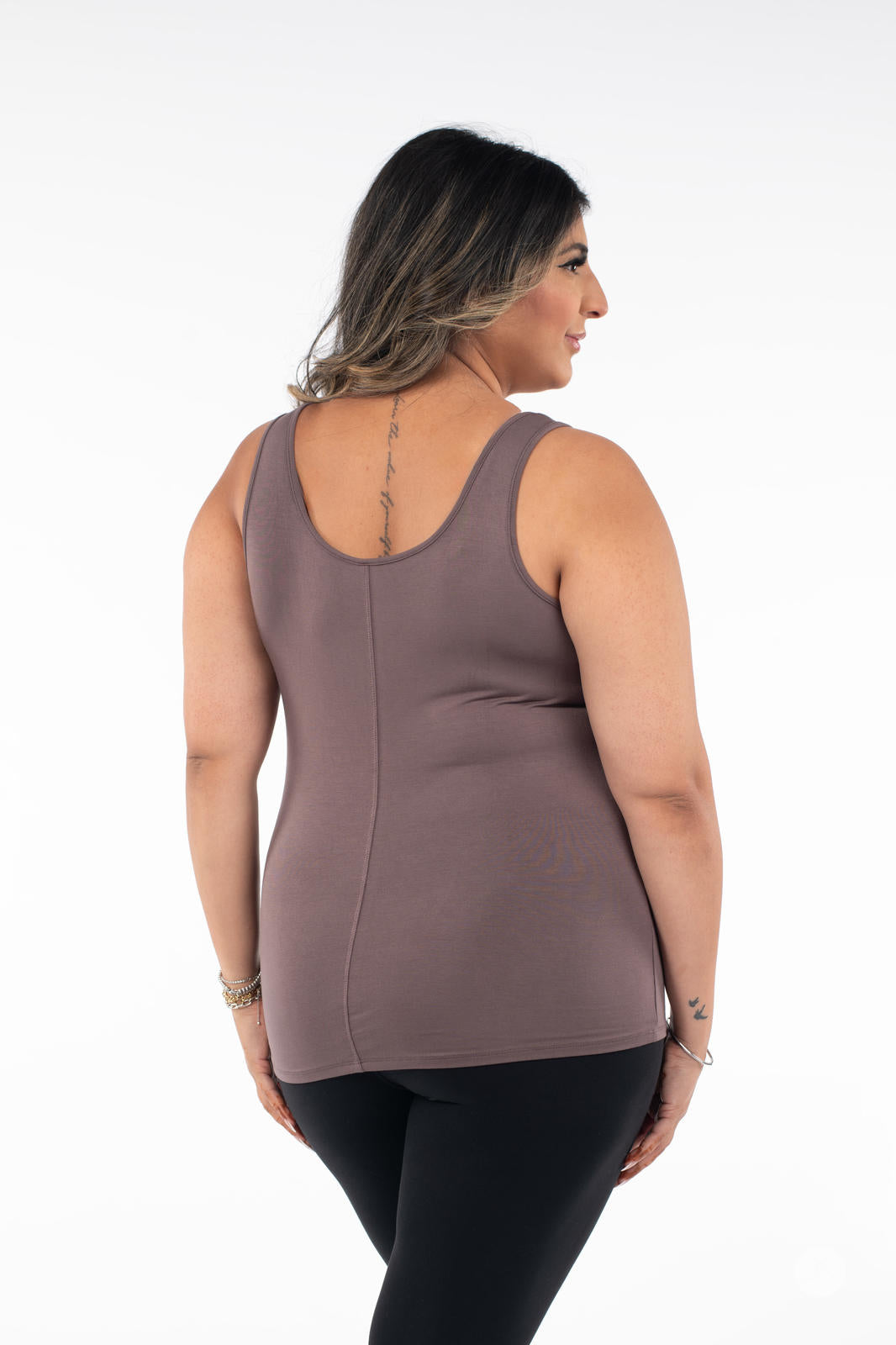 Plus-size woman shown from back wearing SweetLegs Canada Classic Tank in brown paired with black pants on white background