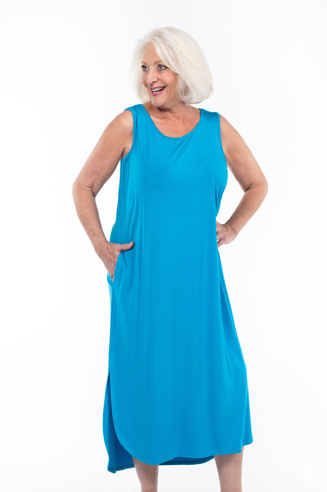 Smiling mature woman wearing SweetTops Sleeveless Tank Dress in bright blue with pockets and side slits