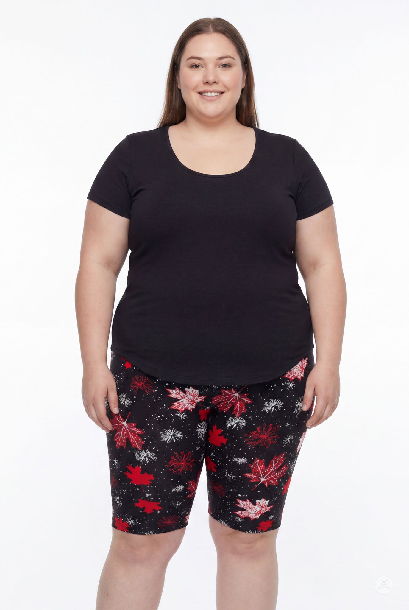 Plus size woman smiling wearing SweetLegs Maple Mood Biker Shorts with red leaf pattern and black t-shirt front view