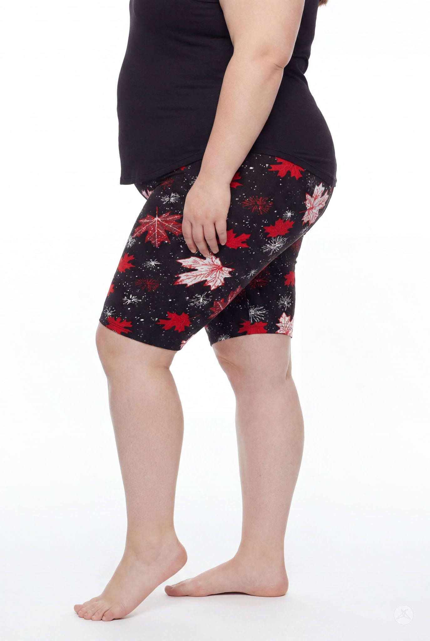 Plus size woman standing barefoot side view wearing SweetLegs Maple Mood Biker Shorts with red maple leaf pattern