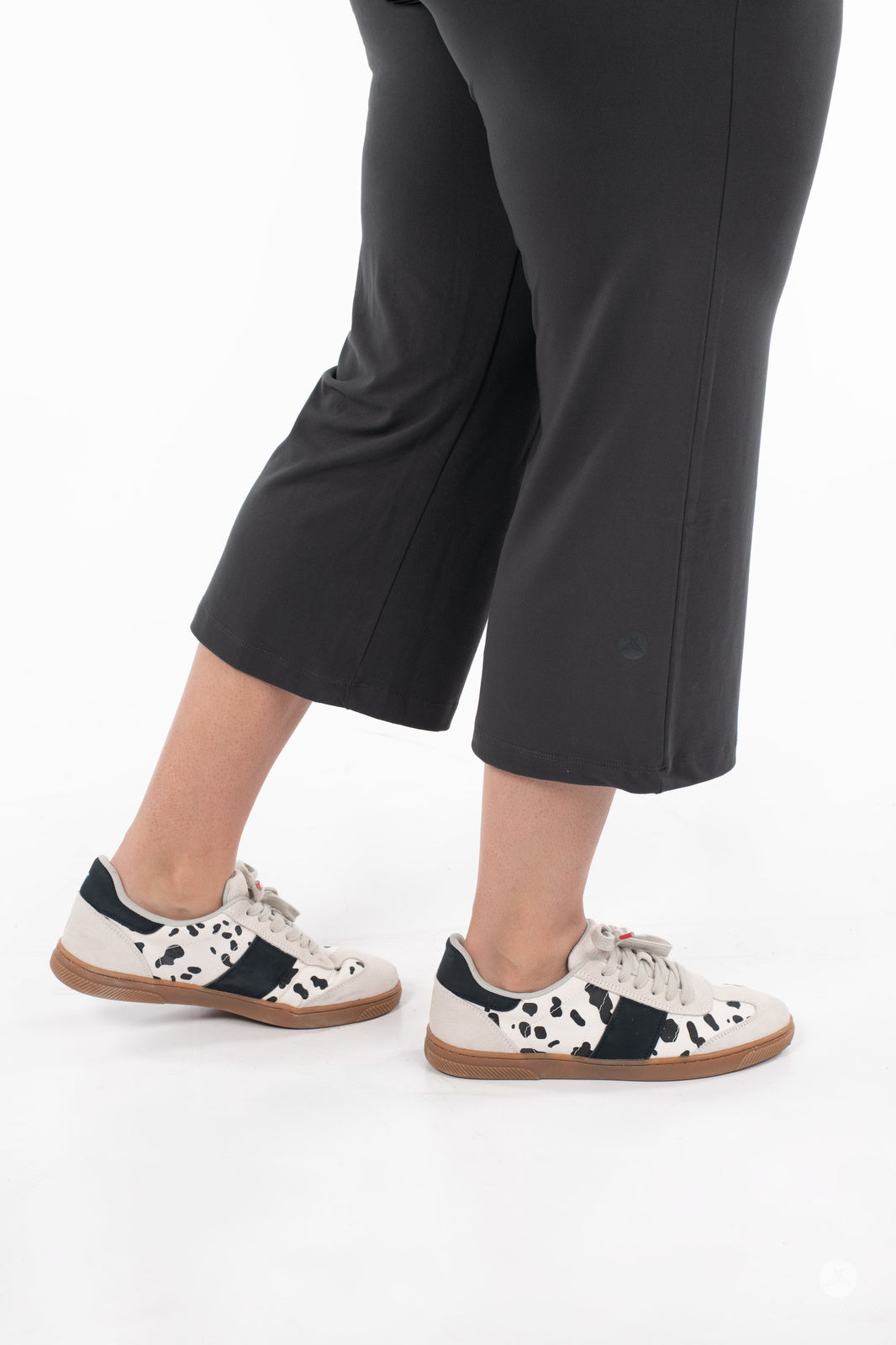 Side view of model wearing SweetLegs High-Waist Wide Leg Crops in black paired with spotted casual sneakers