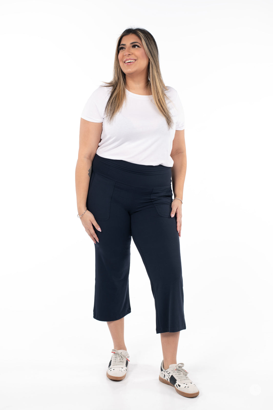 Plus-size model wearing black SweetLegs High-Waist Wide Leg Crops with white t-shirt and sneakers front view