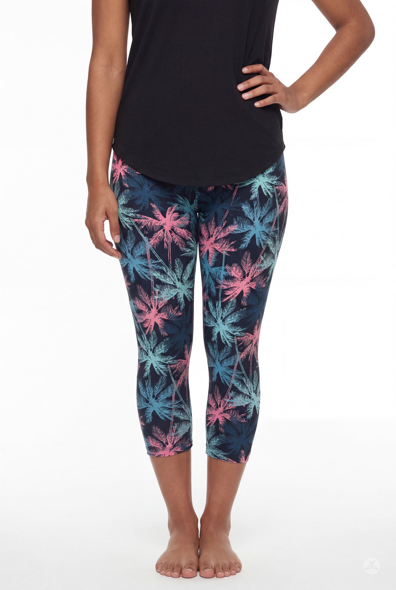 Front view of woman wearing SweetLegs Tiki Nights Crops with colorful palm tree print and black top