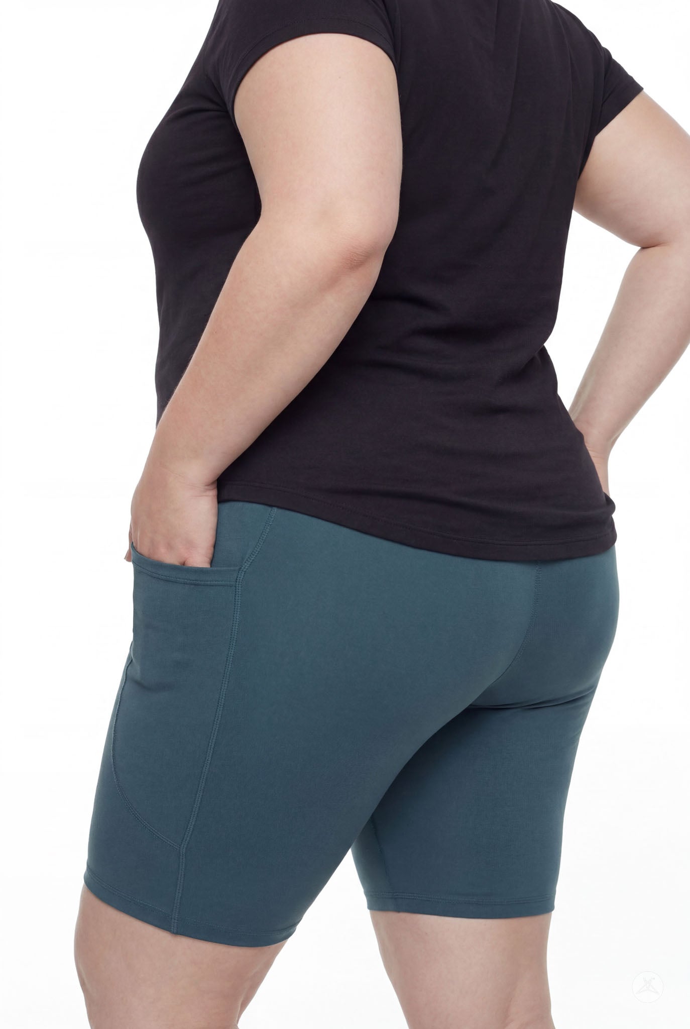 Plus size woman wearing SweetLegs Deep Teal Pocket Biker Shorts with side pocket and black short sleeve top back view