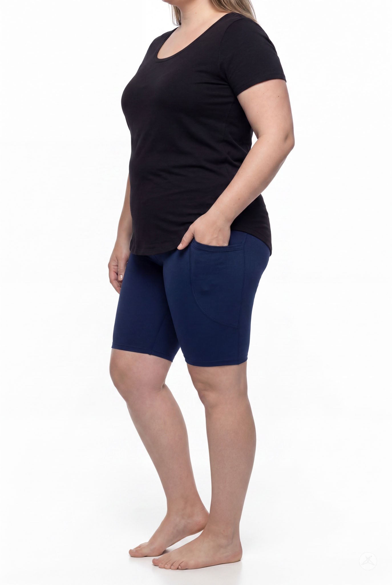 Woman wearing SweetLegs Still Water Pocket Biker Shorts in navy showing side pocket and smooth waistband from side angle