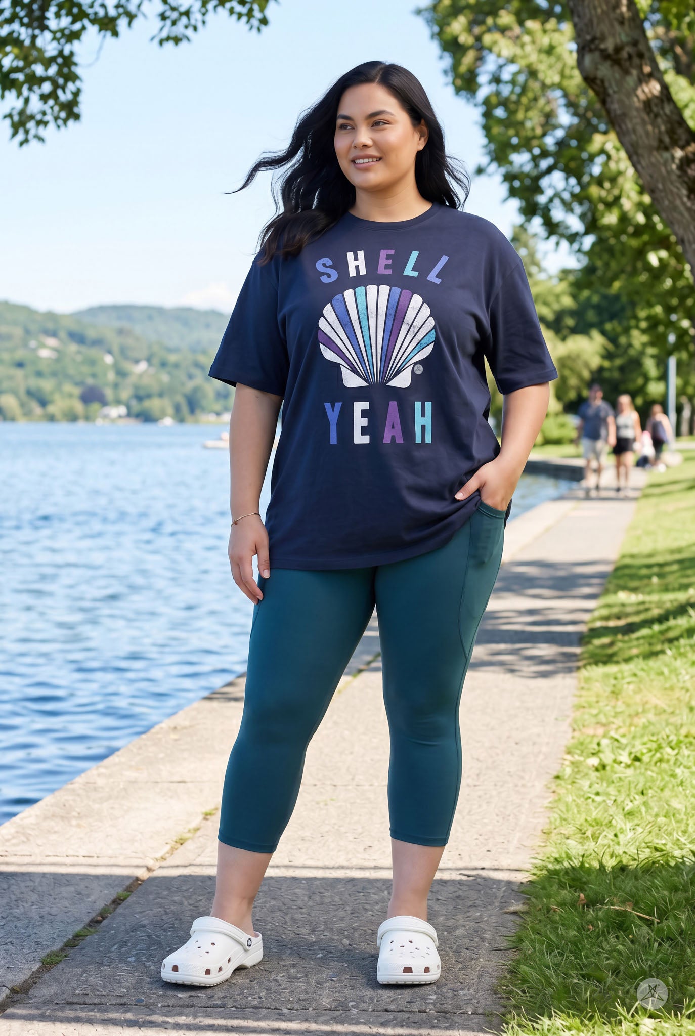Woman standing outdoors by water wearing Deep Teal Pocket Crops by SweetLegs with side pocket visible and casual top