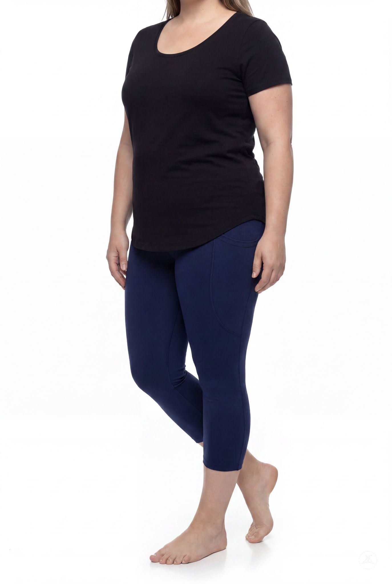 Woman wearing SweetLegs Still Water Pocket Crops navy high-waisted leggings with side pocket barefoot side angle view