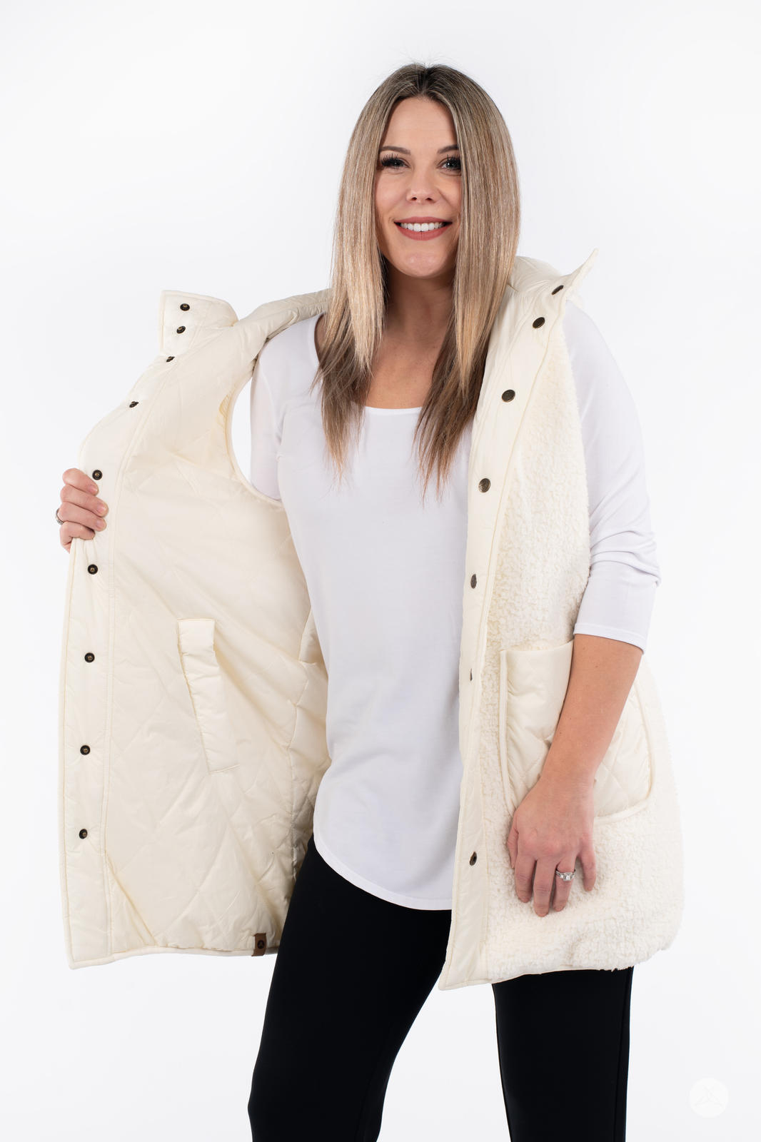 Woman wearing cream SweetLegs Canada Reversible Quilted Sherpa Vest showing inside quilted lining